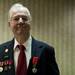 Glenn Dickerson stands with his Knight of the Legion of Honor award on Tuesday. Daniel Brenner I AnnArbor.com